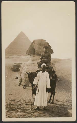 (19-?) ‘Unidentified soldier seated on a camel with Egyptian man at its head, Pyramids and Sphinx in background’, Accession# H99.166/85, Shirley Jones collection of military postcards, State Library of Victoria, Melbourne, VIC.
